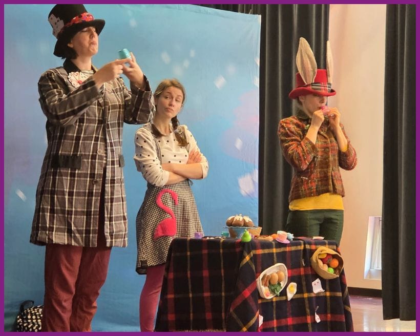 Alice, the Mad Hatter, and the March Hare at a tea party.